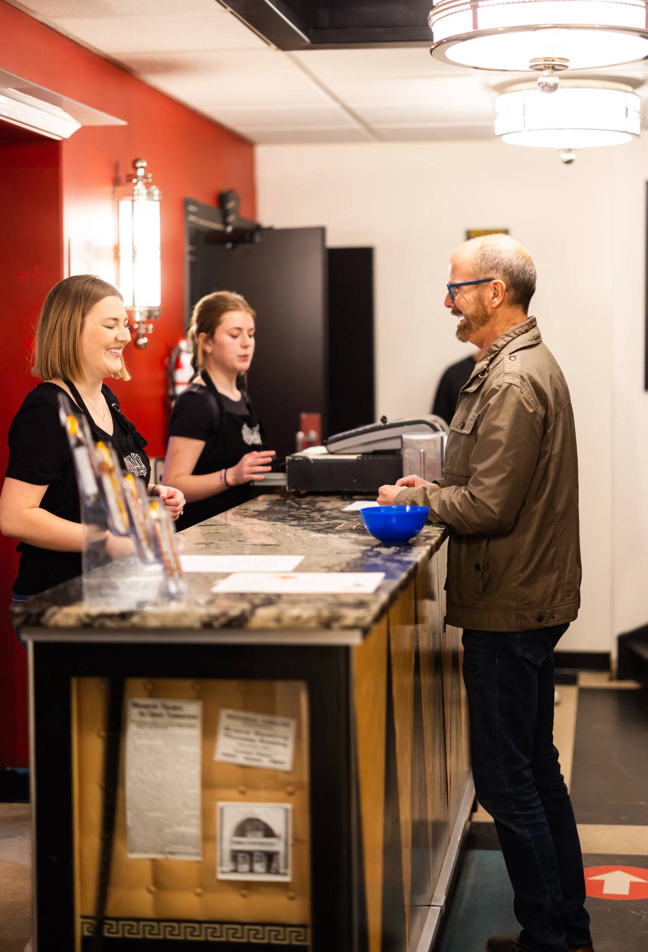 A guy in front of the line of a counter