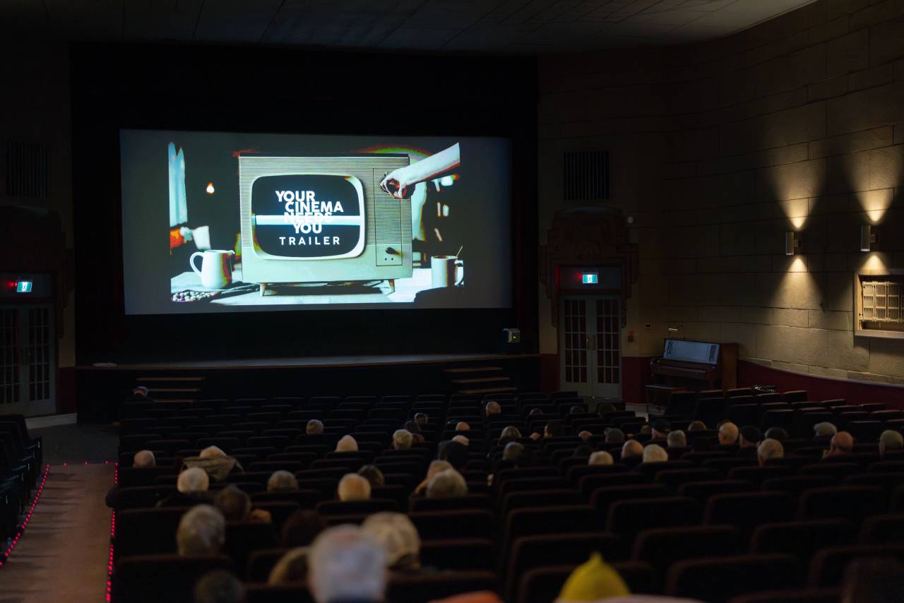 A image of a theatre with people watching inside